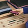 user-pulling-ploom-aura-dark-orchid-device-out-of-drawer